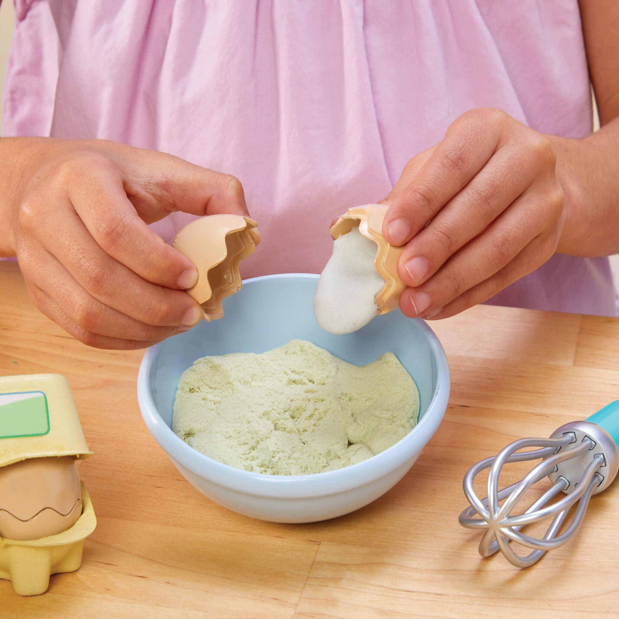 Girl "breaking" a pretend egg